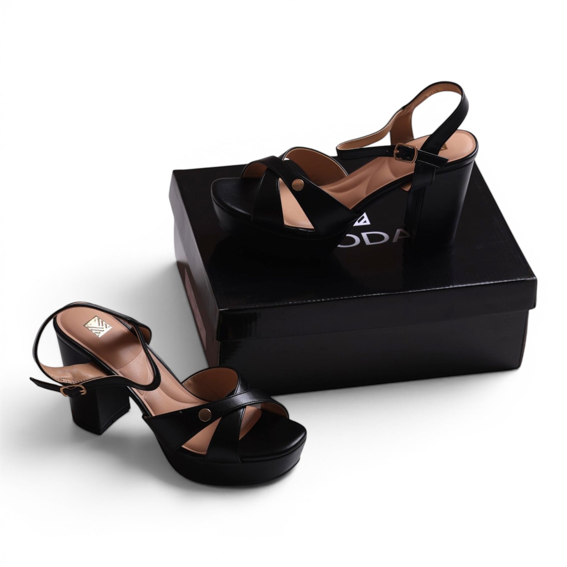 Moda black faux leather platform sandals with criss-cross straps and ankle buckle closure.