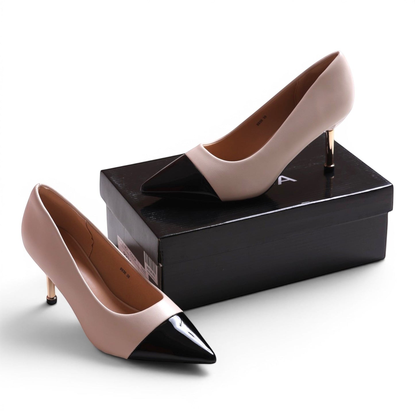 Moda Ug beige and black two-tone pointed-toe pumps with gold stiletto heel.