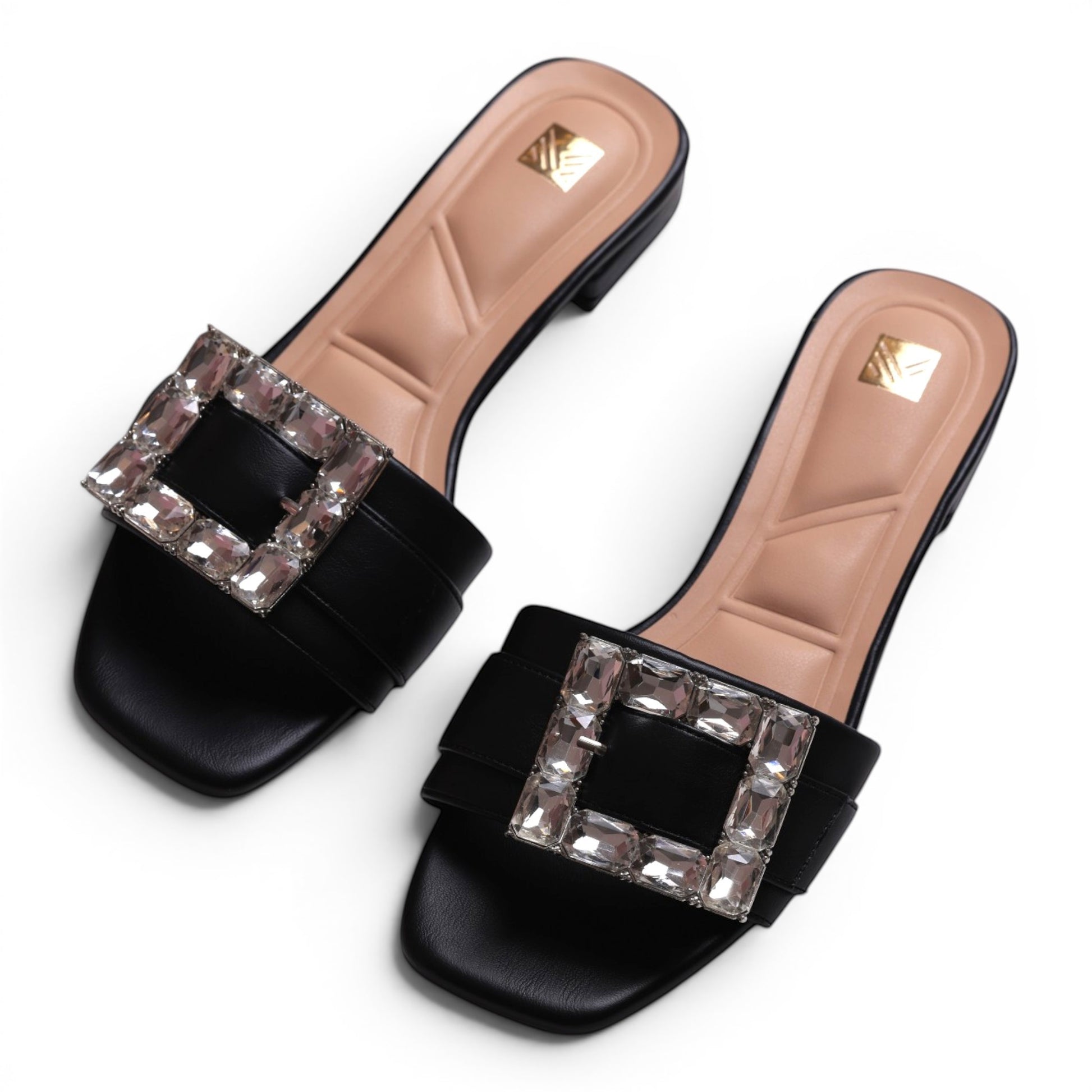 Moda Ug black slide sandals with square crystal embellishments and cushioned tan insoles.