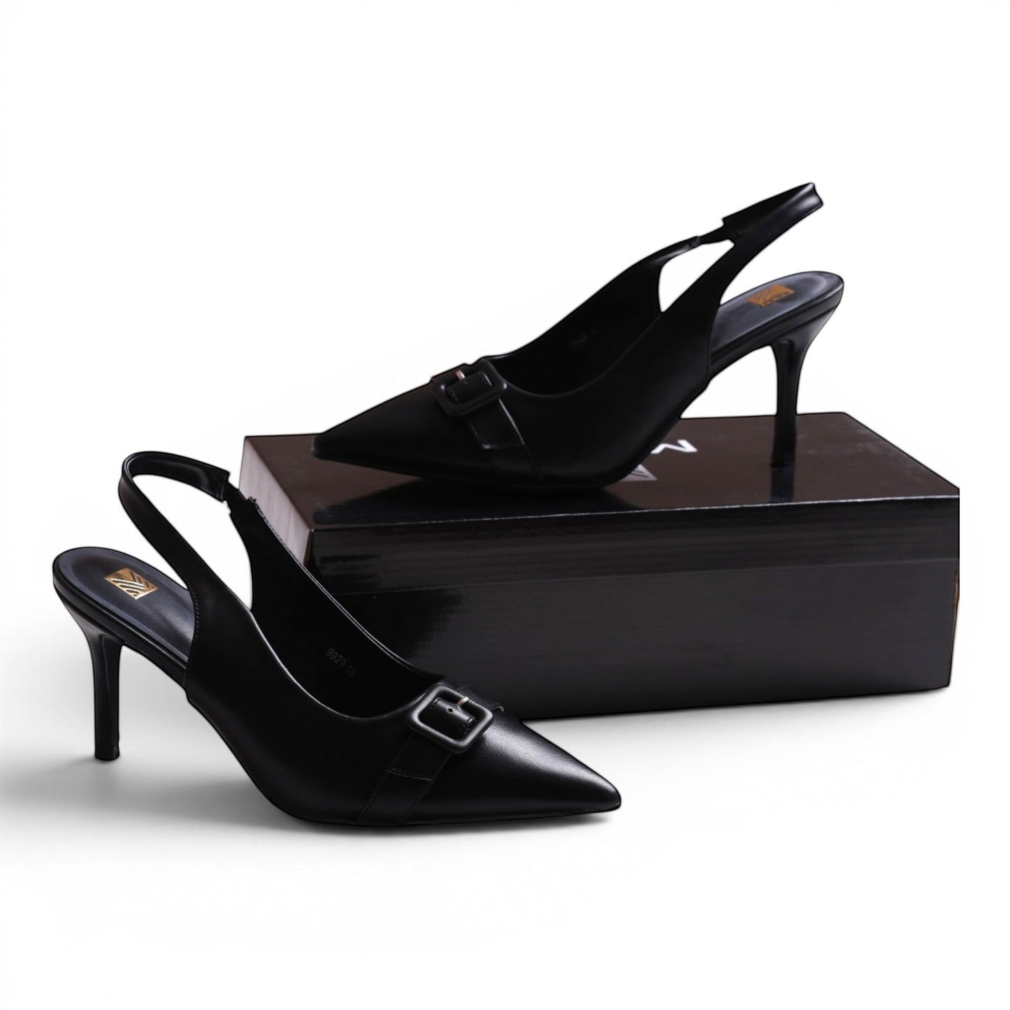 Moda Ug black faux leather slingback heels with pointed toe and buckle detail.