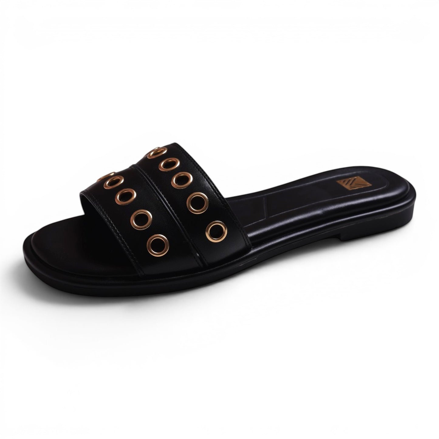 Moda Ug black faux leather slide sandals with gold grommet details and a flat sole.