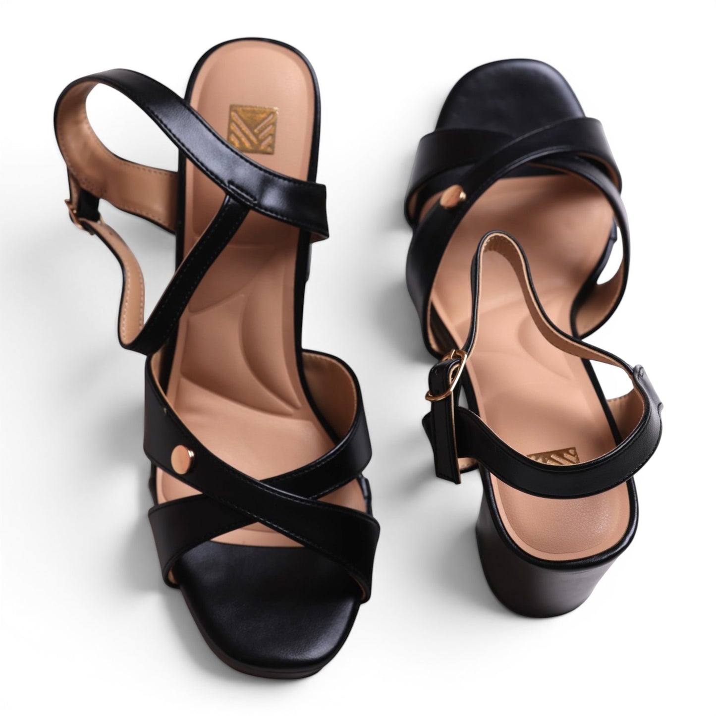 Moda Ug black faux leather criss-cross strap heeled sandals with ankle strap and buckle closure.