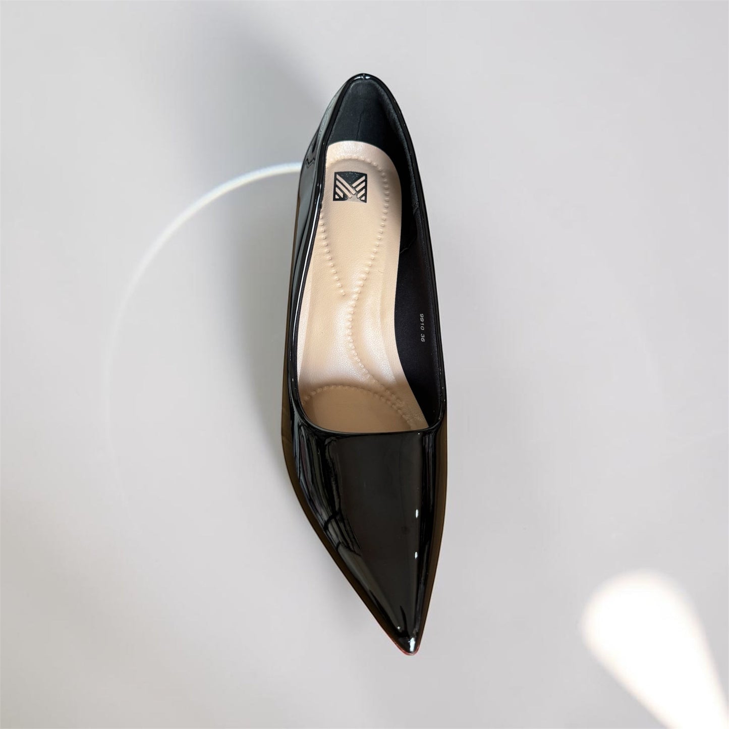 Moda Ug black patent leather pointed toe high heel pumps with cushioned insole.