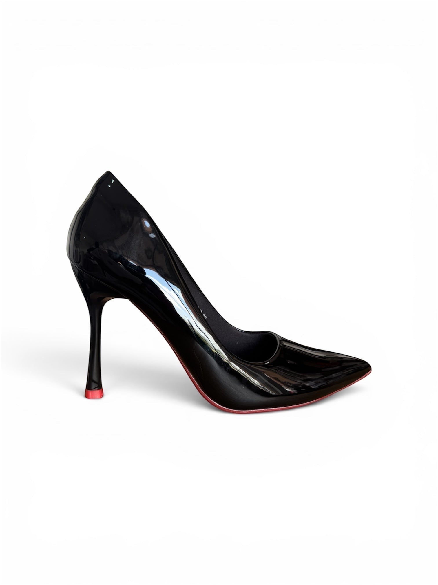 Moda Ug black patent leather pointed toe high heel pumps with a slender heel and red sole.