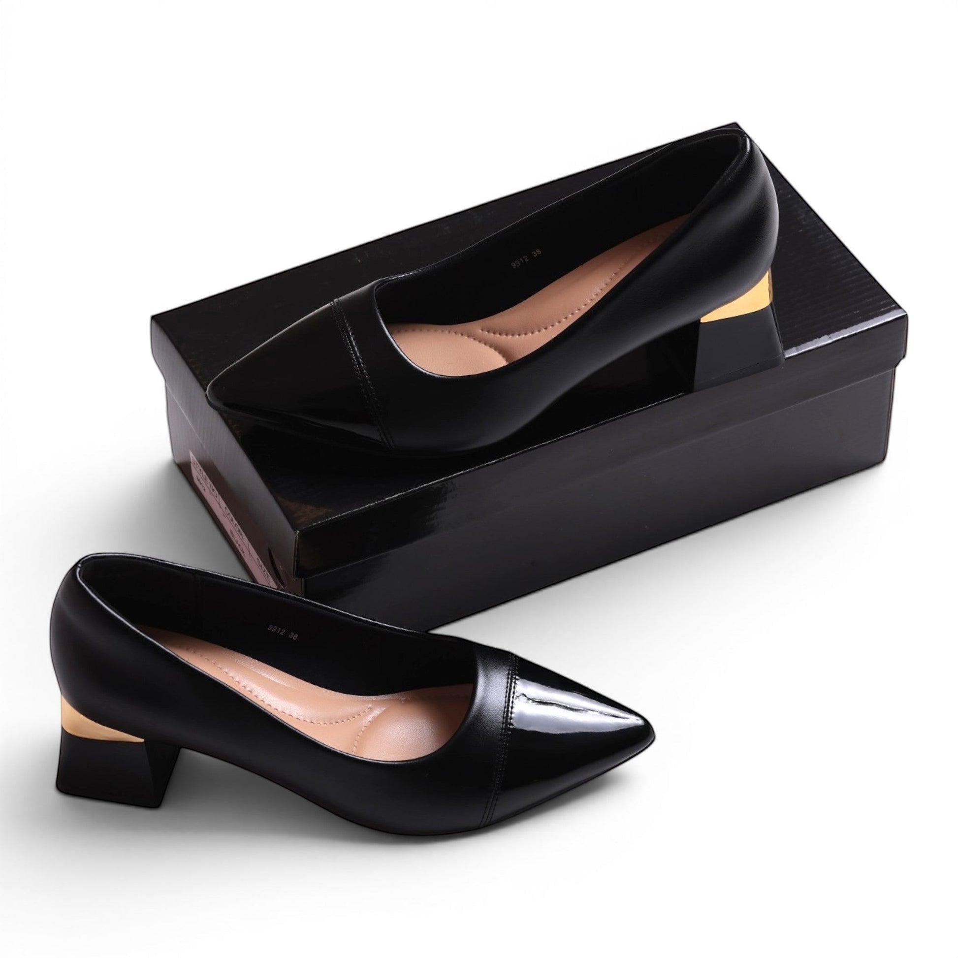 Moda Ug black patent leather pointed toe block heel pumps with gold accent.