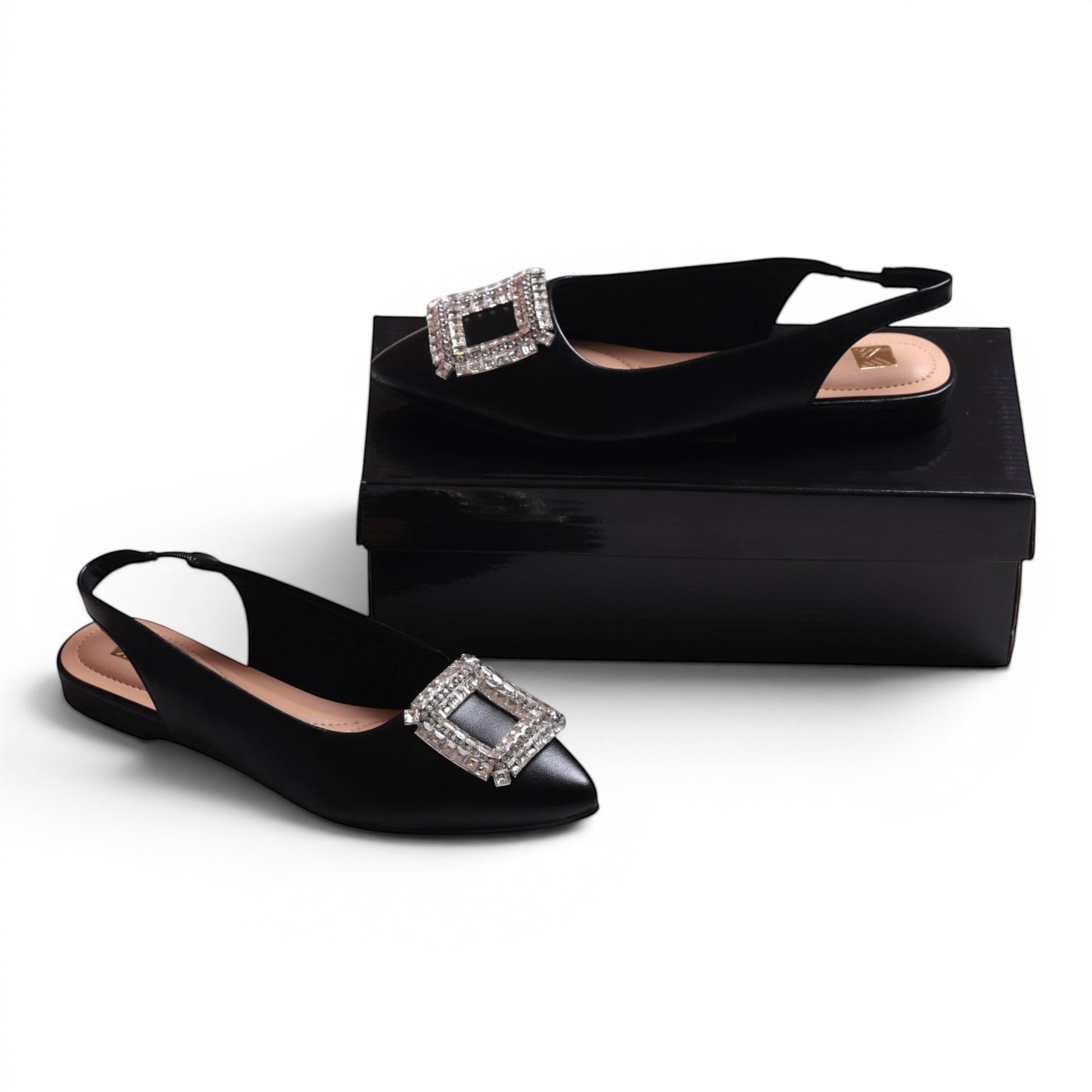 Moda Ug black slingback flats with pointed toe and square rhinestone buckle detail.