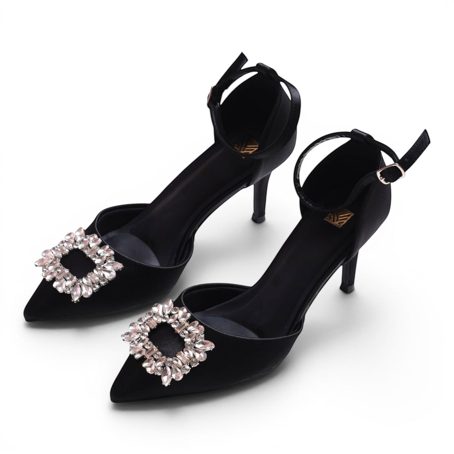 Moda Ug black satin pointed-toe heels with ankle strap and crystal embellishment.