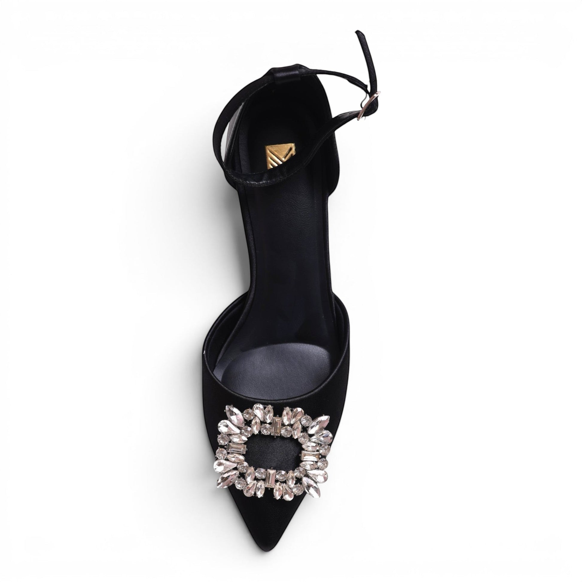 Moda Ug black satin pointed-toe pump with ankle strap and crystal buckle detail.
