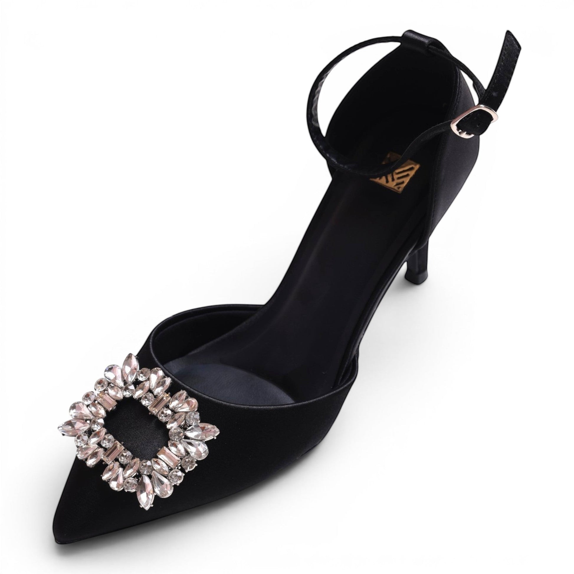 Moda Ug black satin pointed-toe pump with ankle strap and crystal embellishment on toe.