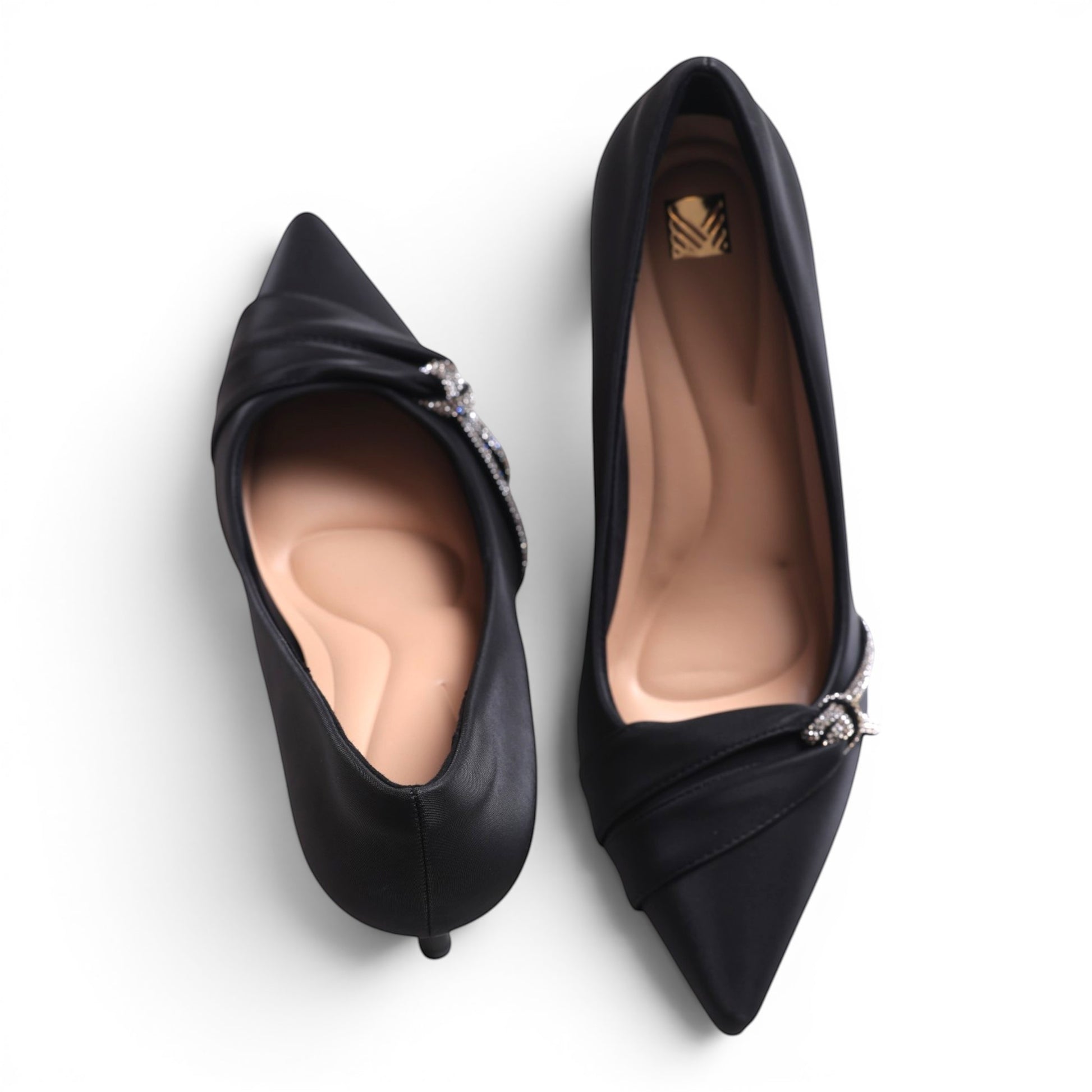 Moda Ug black satin pointed-toe pumps with crystal embellishment and ruched detail.