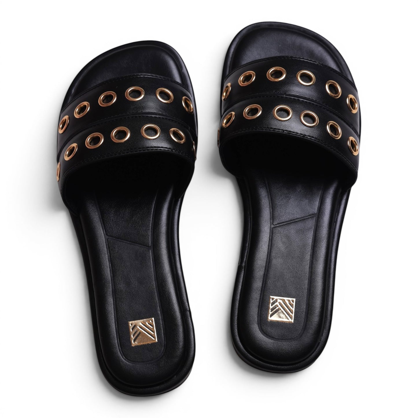 Moda Ug black faux leather slide sandals with gold eyelet details and a square toe.