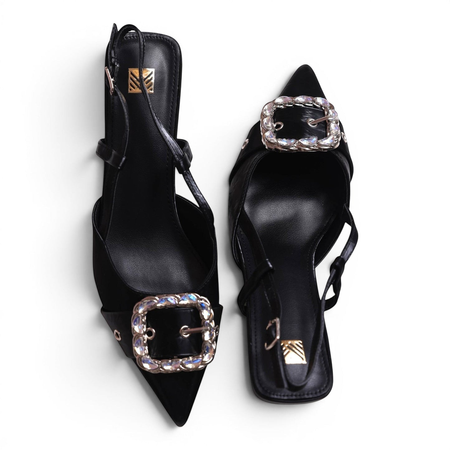Moda Ug black pointed-toe slingback heels with crystal-embellished buckles and adjustable ankle straps.