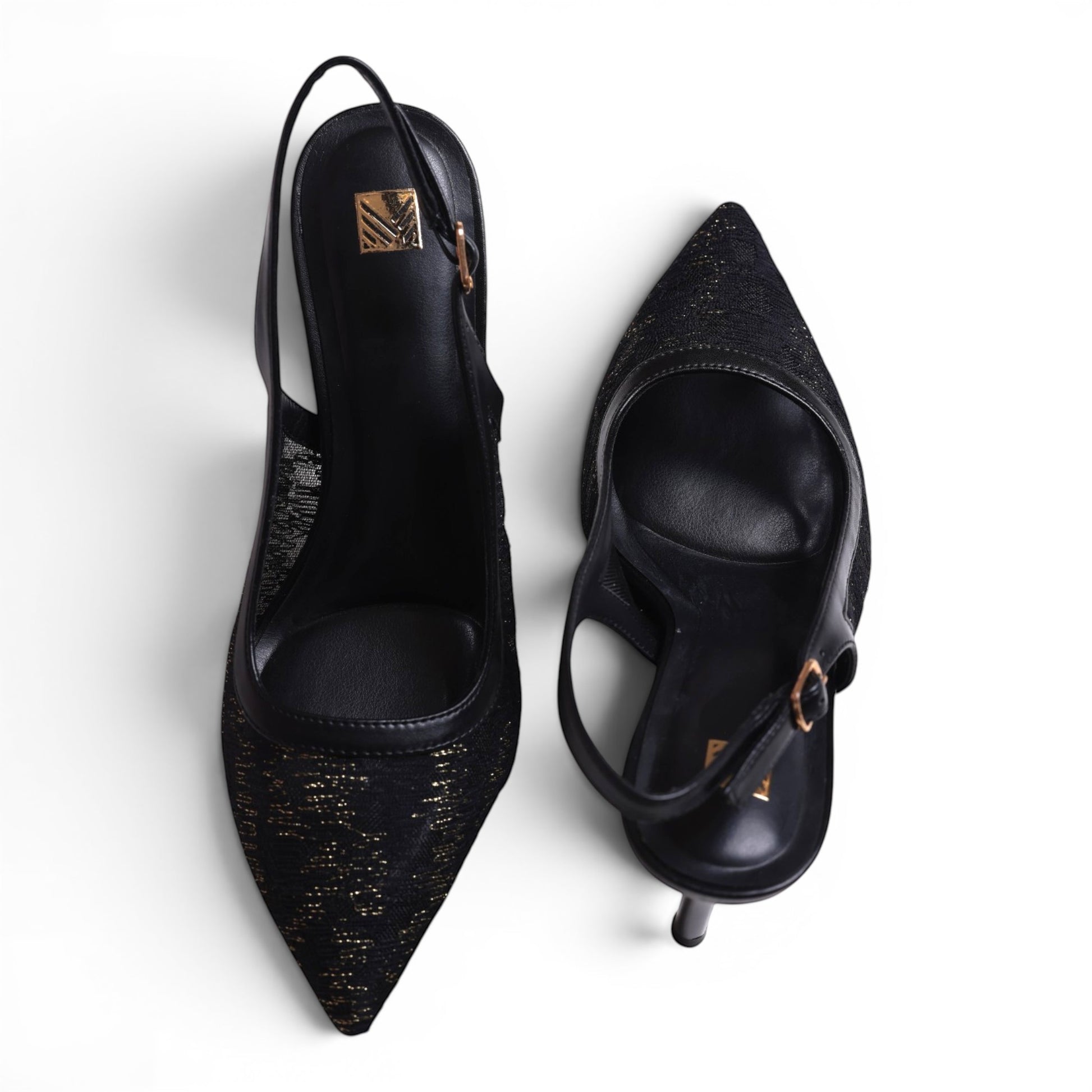 Moda Ug black slingback heels with pointed toe and gold glitter detail. Sling strap with buckle closure.