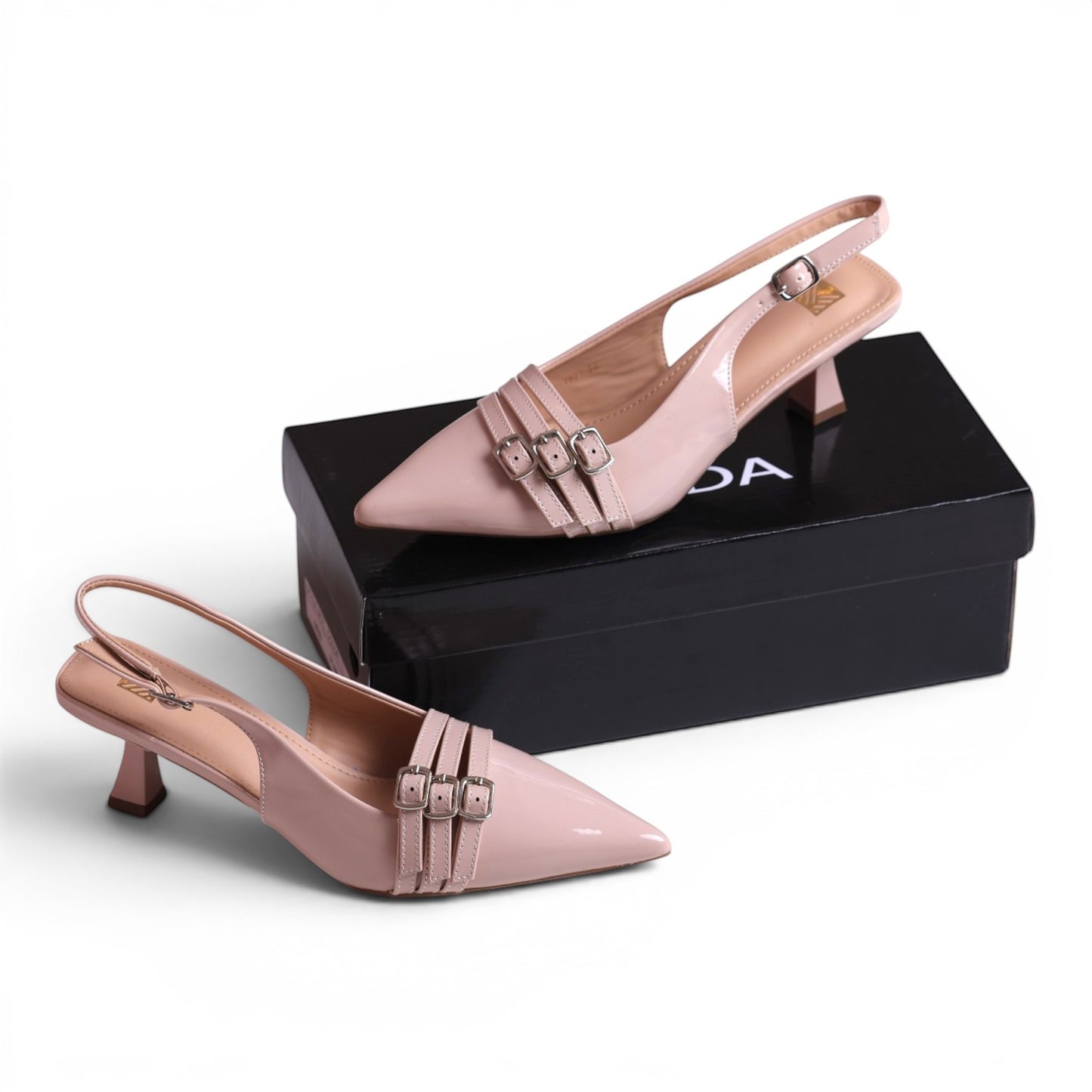 Moda Ug women's blush pink patent leather slingback kitten heel dress shoes with pointed toe and triple buckle straps.