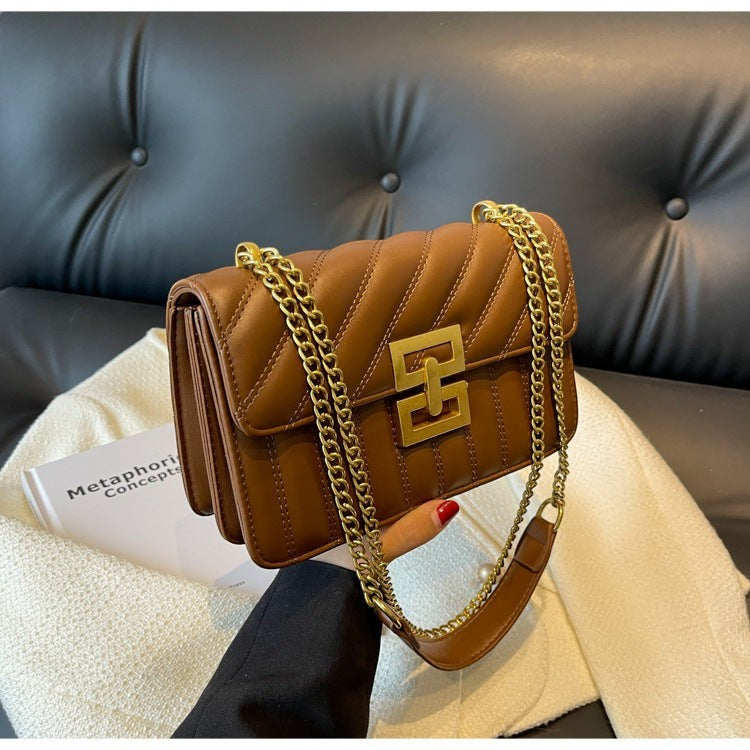 Moda Ug brown quilted PU leather small square crossbody handbag with gold chain strap and gold clasp.