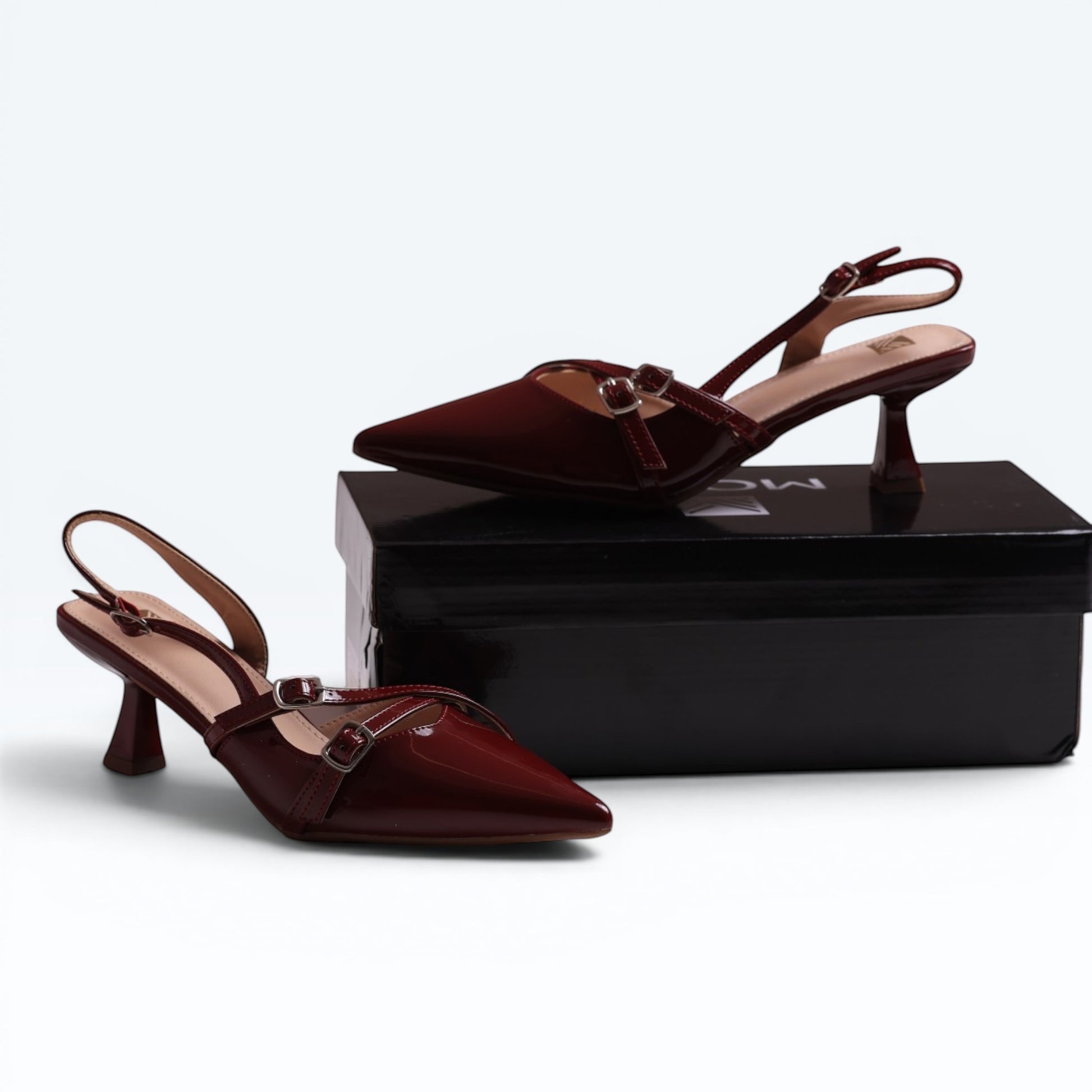 Moda Ug patent wine-red burgundy and black multi-strap slingback heels with pointed toe and kitten heel.
