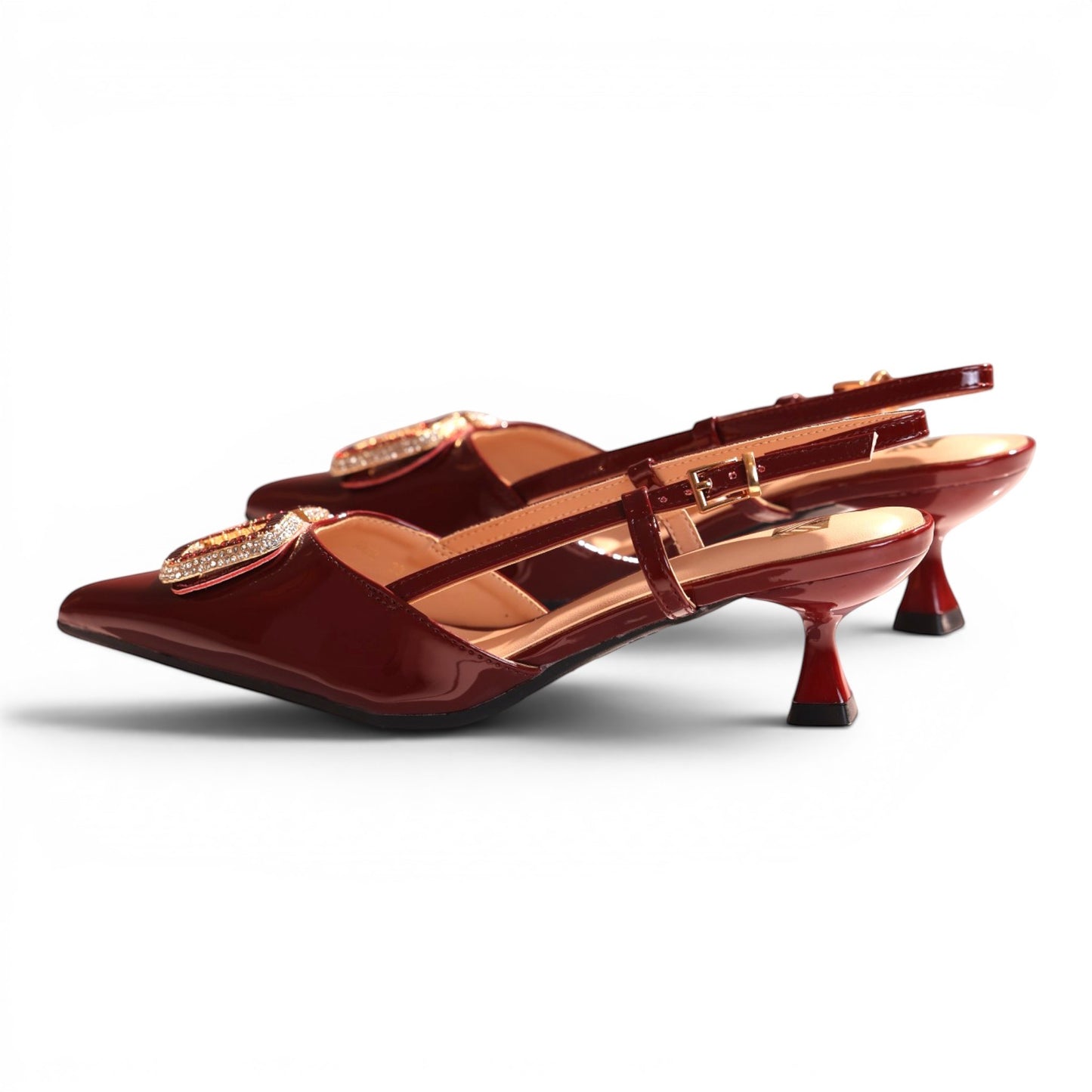 Moda Ug burgundy patent leather slingback heels with rhinestone buckle detail and adjustable ankle strap.