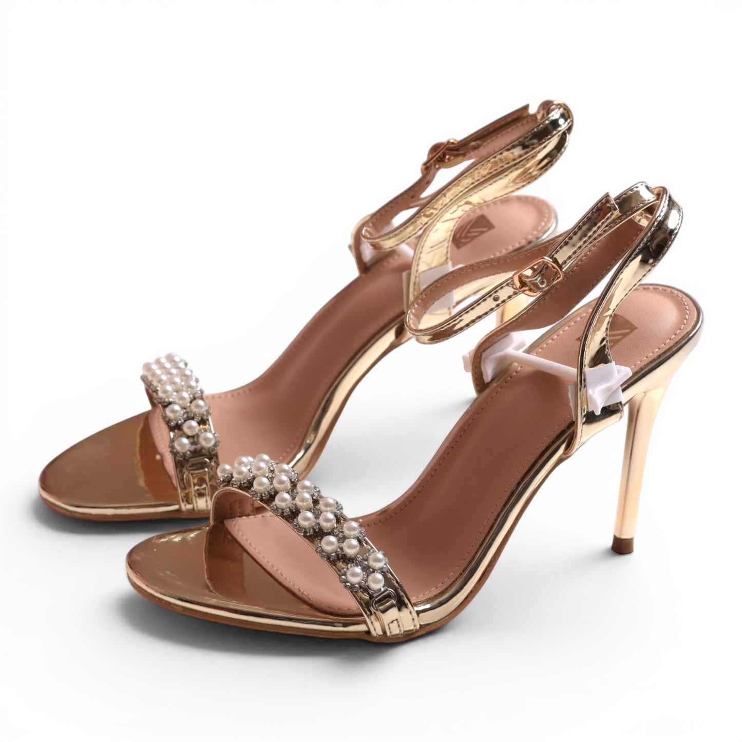 Moda Ug gold metallic stiletto sandals with pearl and rhinestone embellishments on the strap.