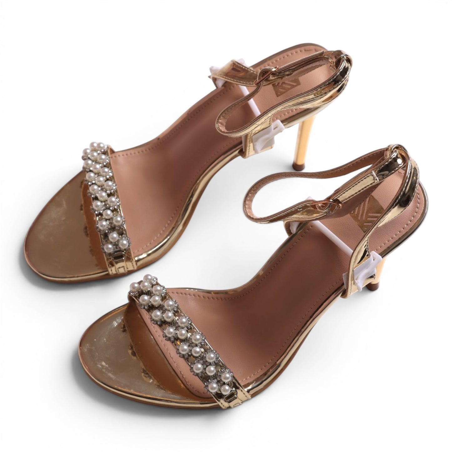 Moda Ug gold metallic heeled sandals with pearl and rhinestone embellished strap and ankle strap.