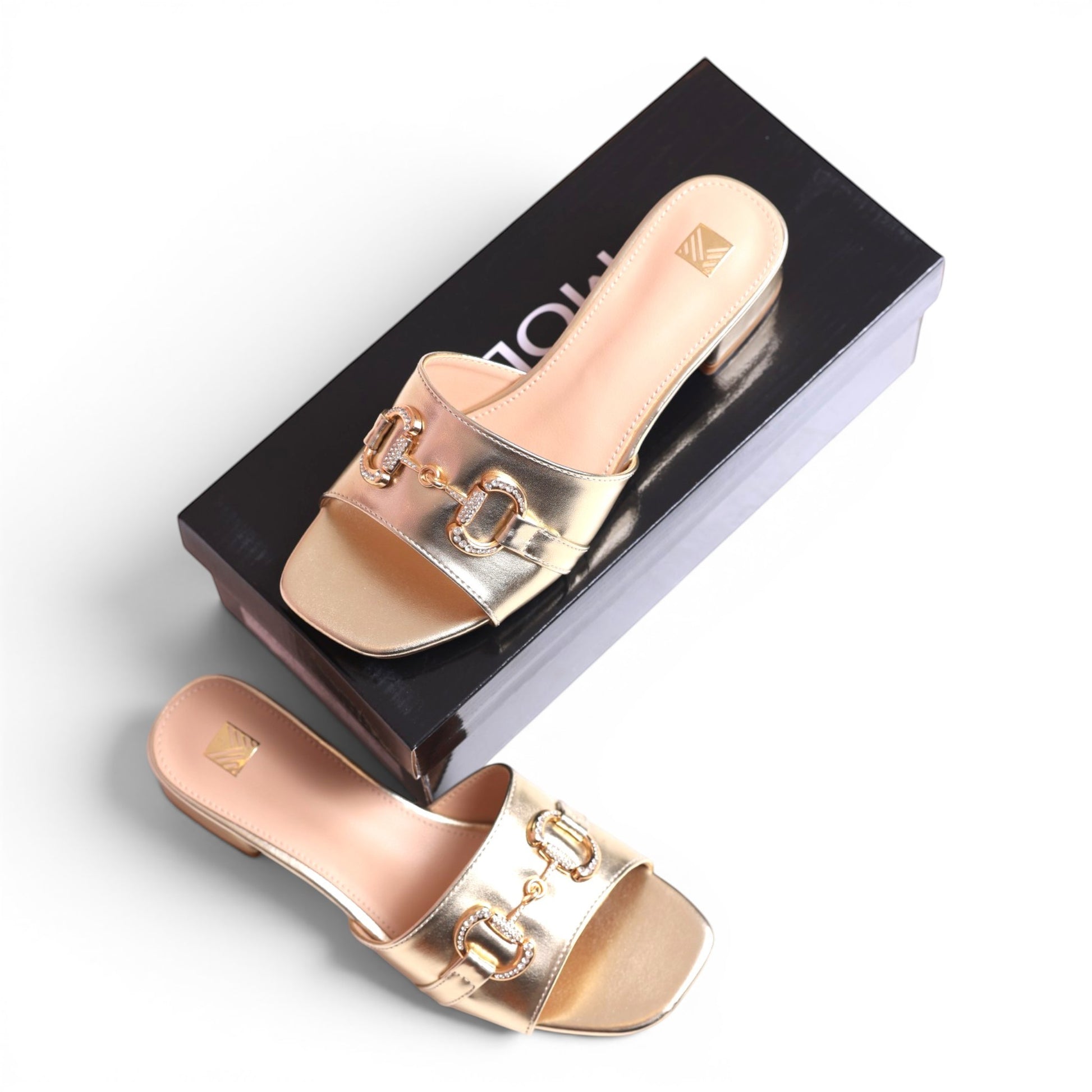 Moda Ug gold metallic slide sandals with buckle and crystal detail, square toe, low heel.