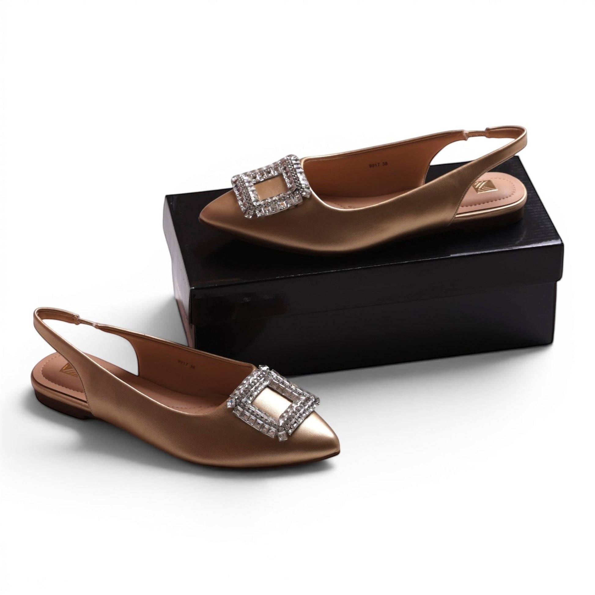 Moda Ug gold slingback flats with pointed toe and crystal-embellished buckle detail.