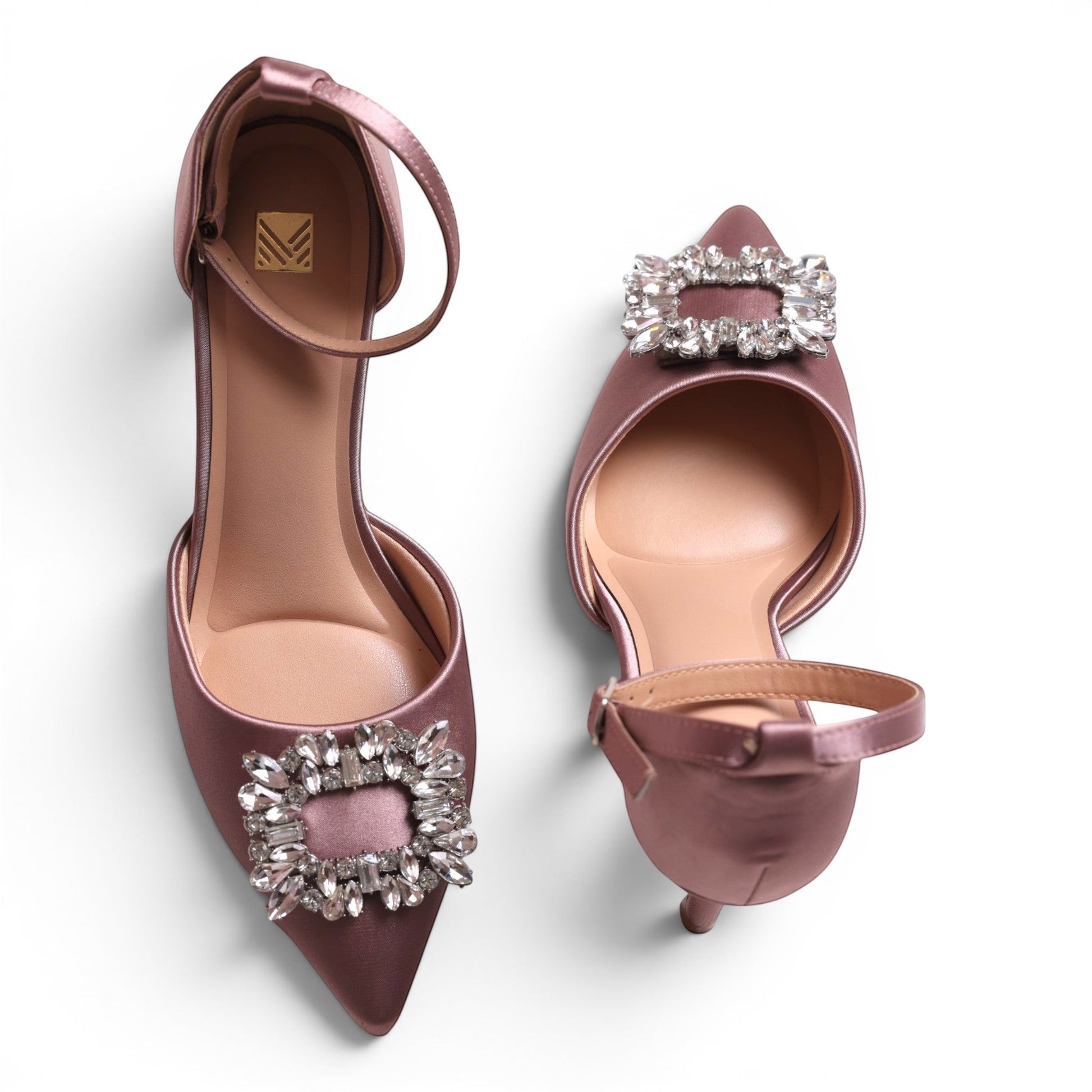 Moda Ug women's mauve satin pointed-toe pumps with ankle strap and crystal embellishment.