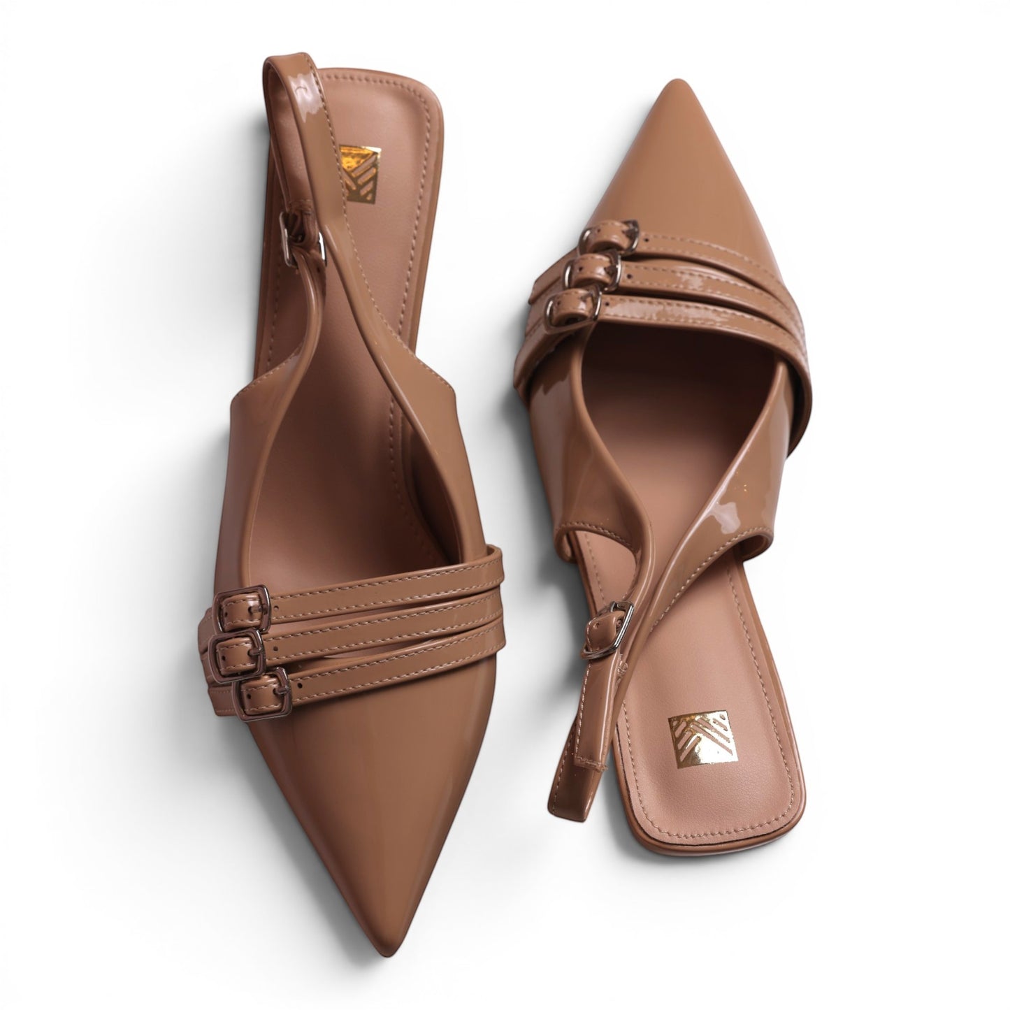 Moda Ug women's patent leather slingback kitten heel dress shoes in nude with pointed toe and triple buckle straps.