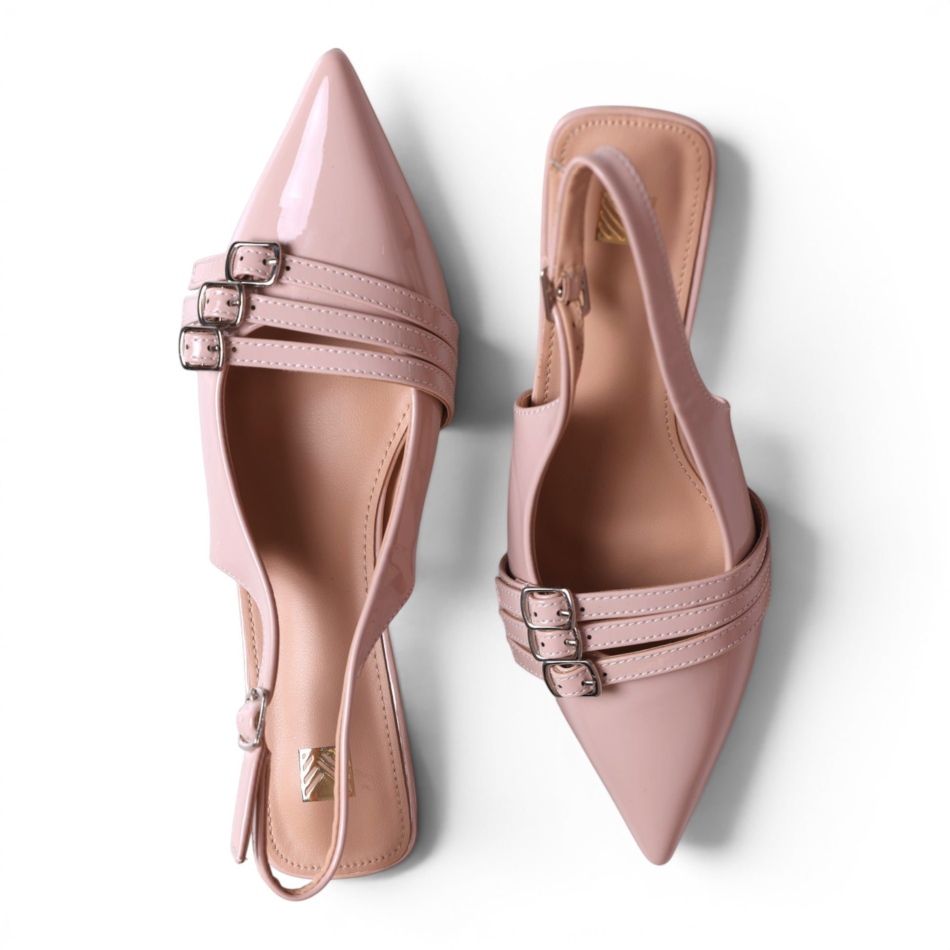 Moda Ug pink patent leather slingback flats with pointed toes and triple buckle straps.