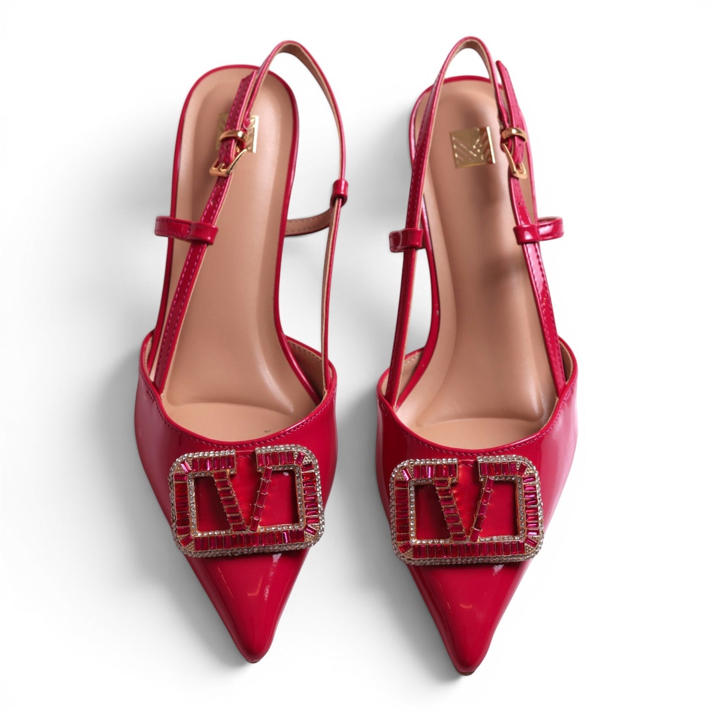 Moda Ug red patent leather slingback heels with crystal embellished logo detail and pointed toe.
