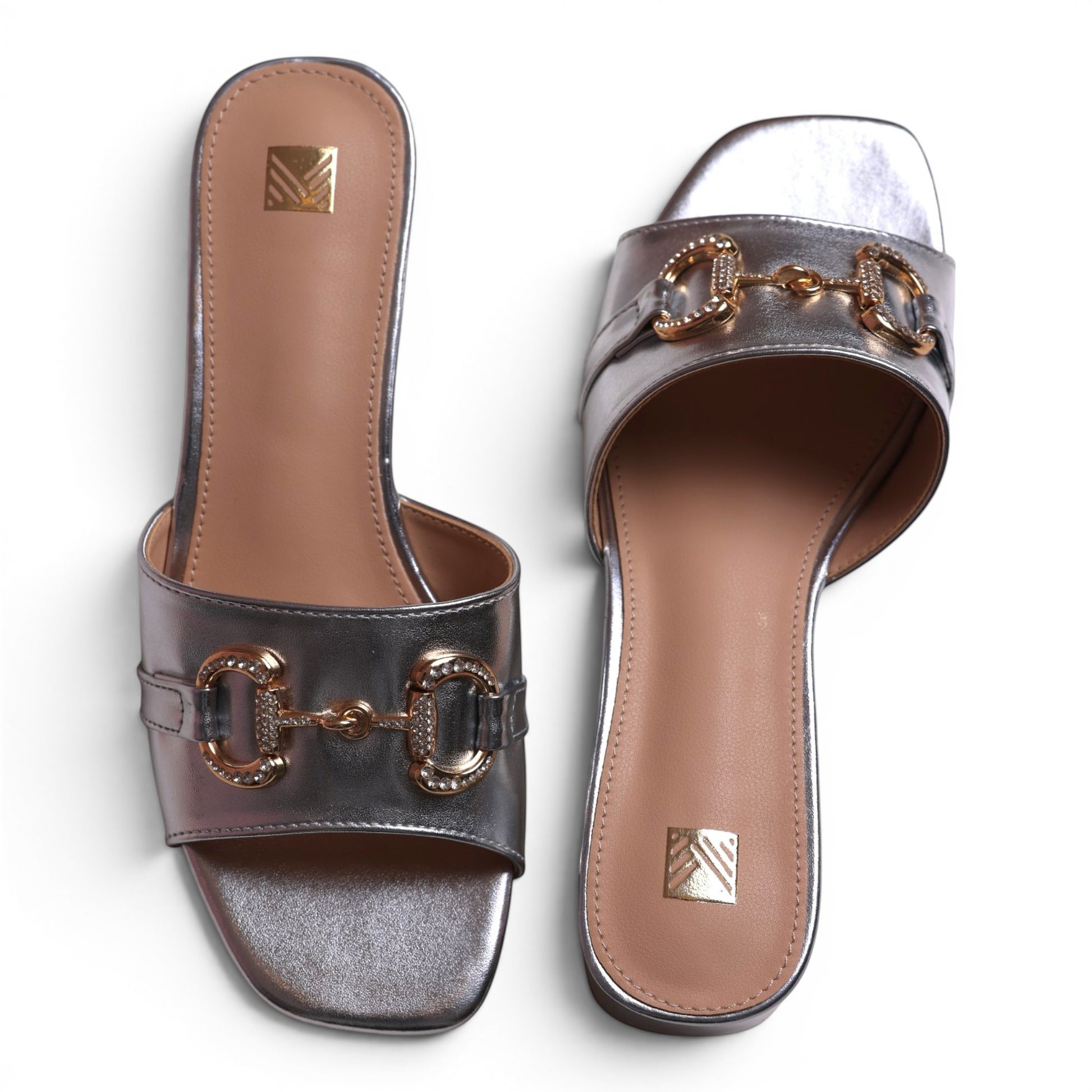 Moda Ug silver metallic slip-on sandals with gold bit and crystal embellishments, square toe.