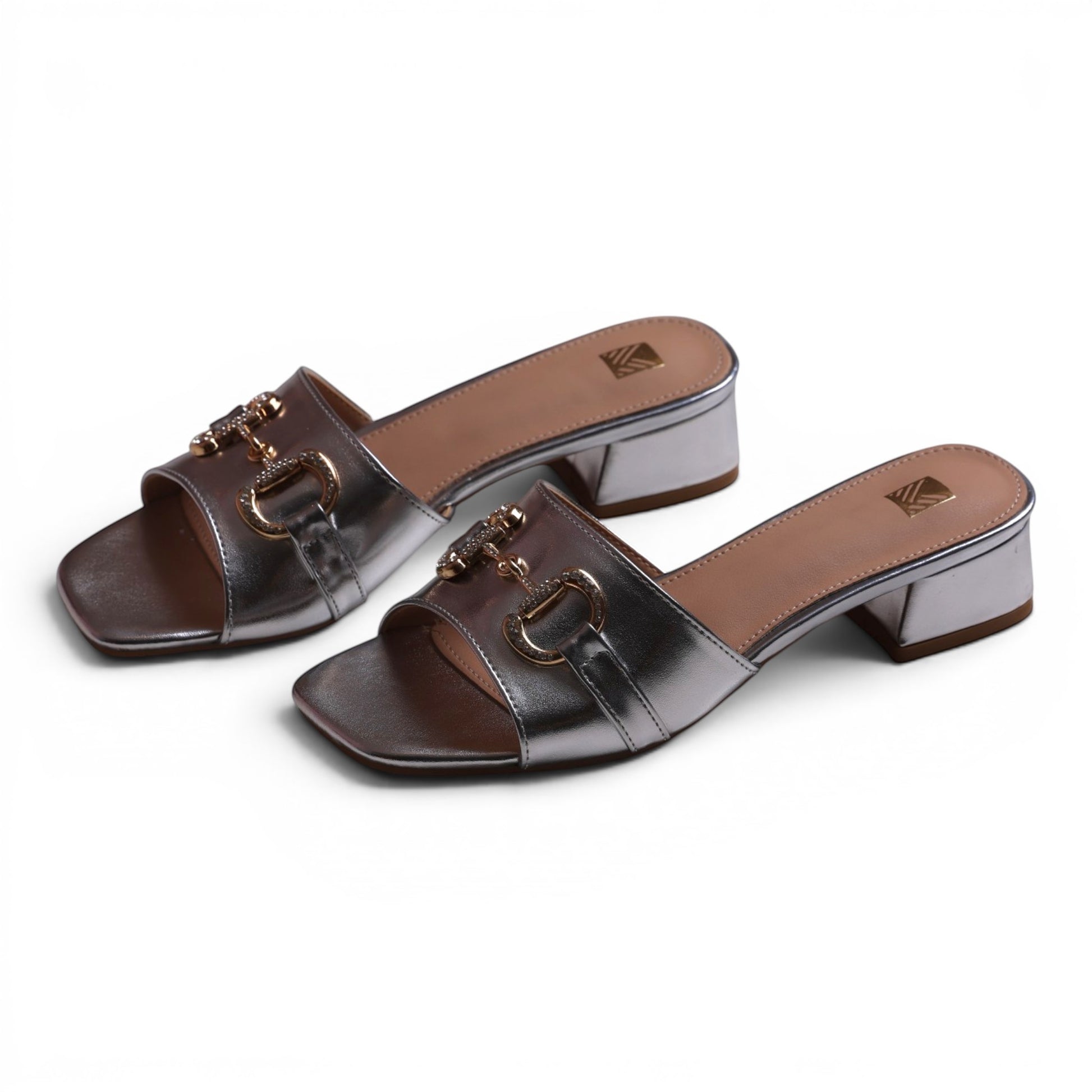 Moda Ug silver metallic slip-on block heel sandals with gold horsebit detail and square toe.