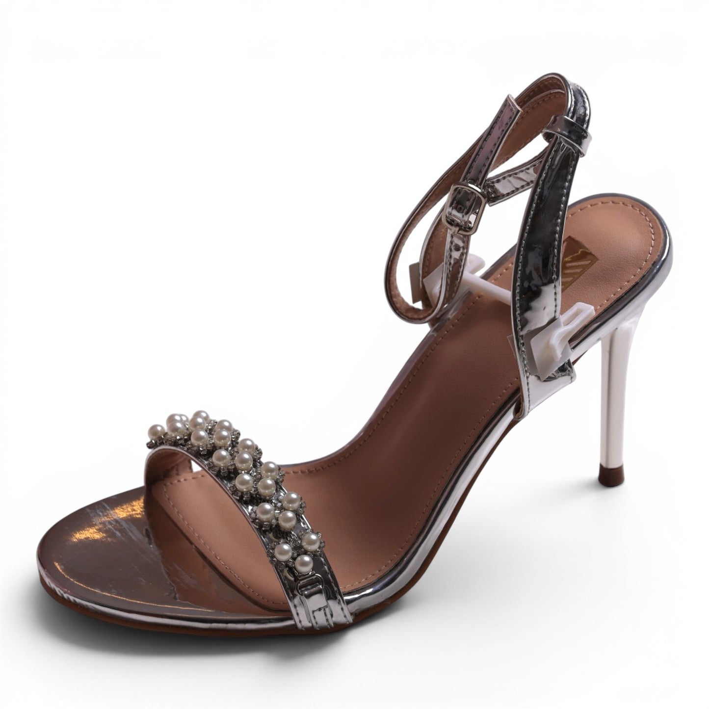 Moda Ug silver metallic stiletto sandal with pearl and rhinestone embellishments on the strap and ankle strap.