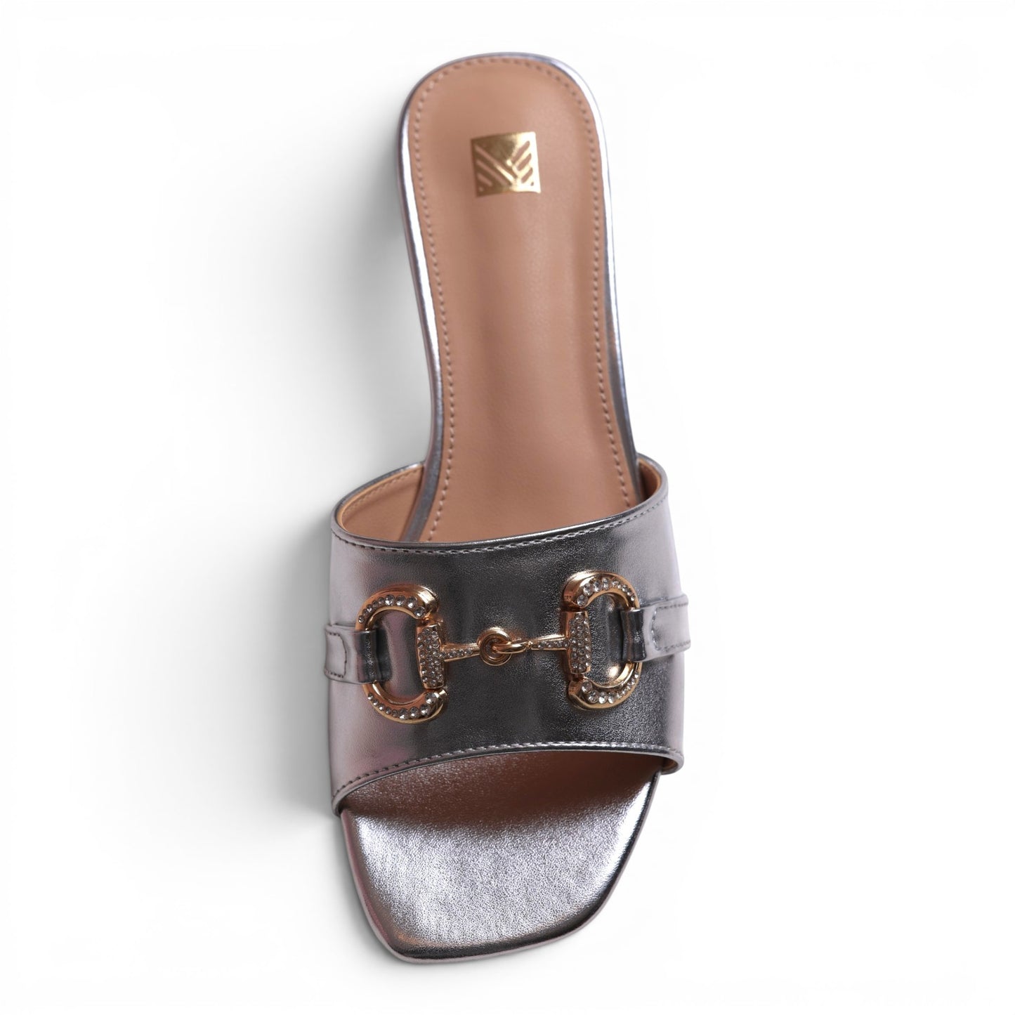 Moda Ug silver metallic slip-on mule sandals with gold horsebit detail and crystal embellishments.