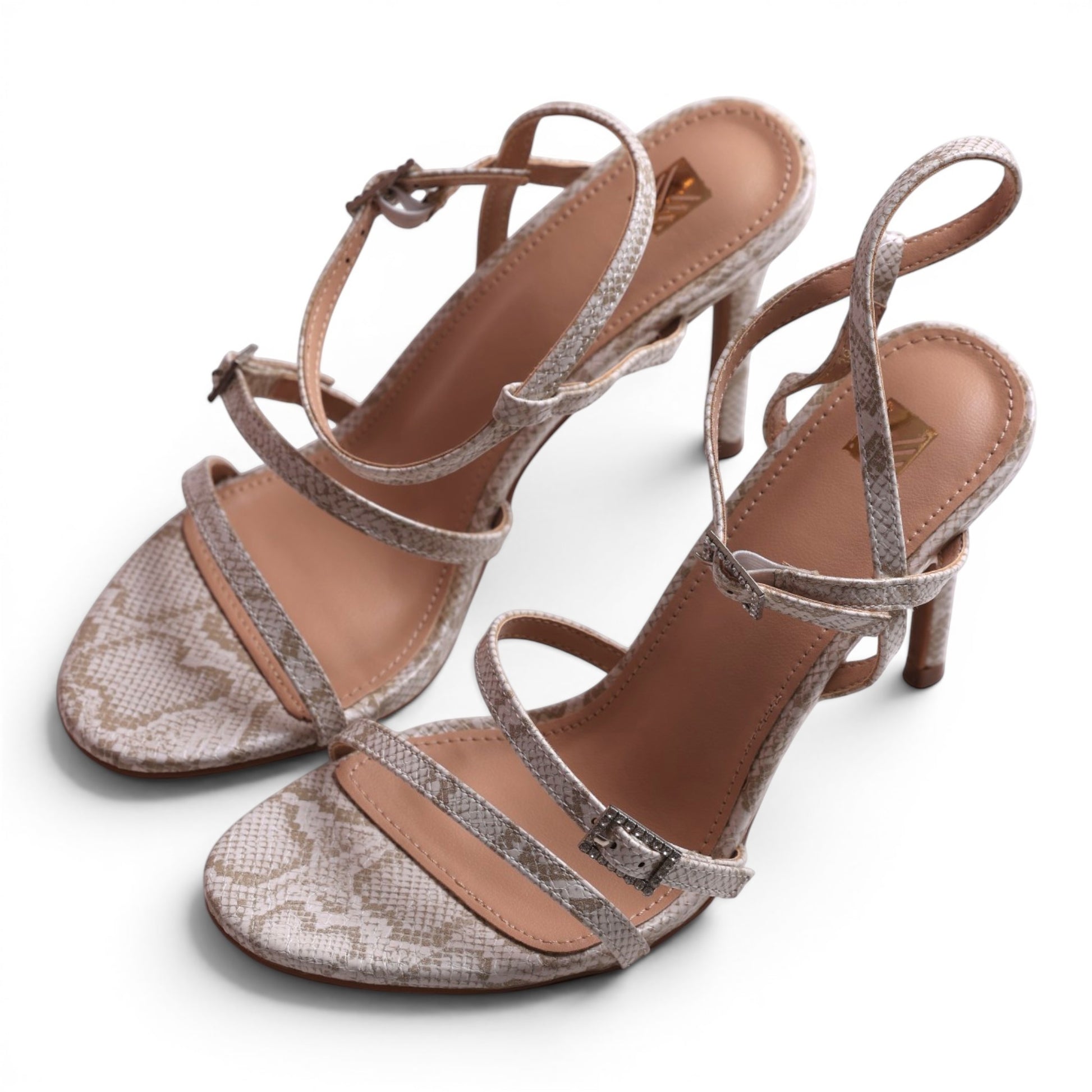 Moda Ug strappy heeled sandals with a beige and white snakeskin print and buckle detail.