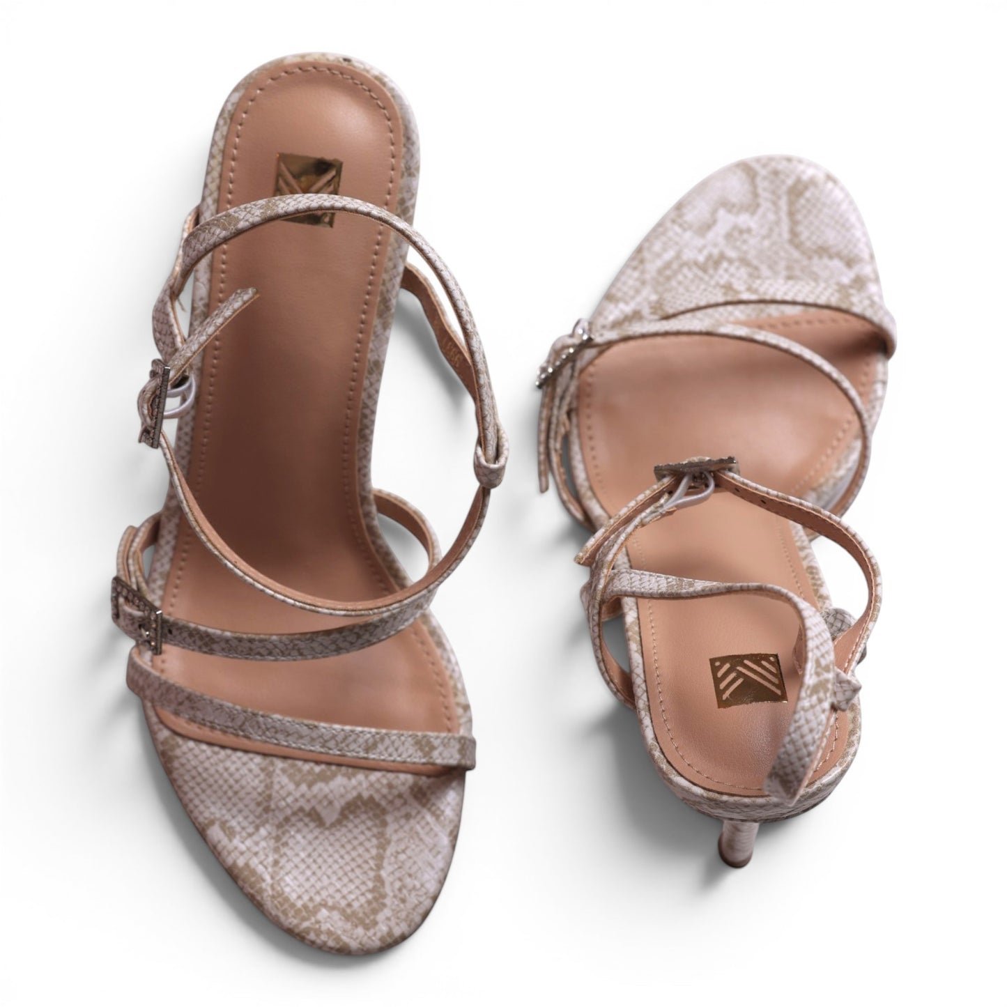Moda Ug strappy heeled sandals in beige snake print with buckle closure.