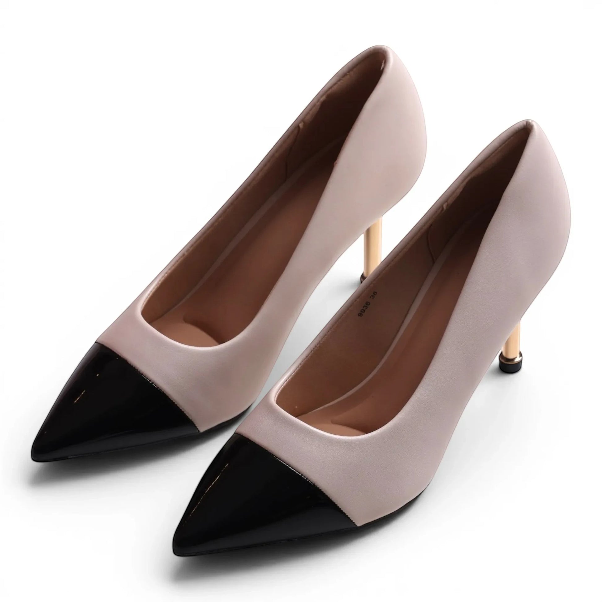 Moda Ug Two-Tone Pointed Toe High Heel Pumps in nude faux leather with black toe and gold heel.