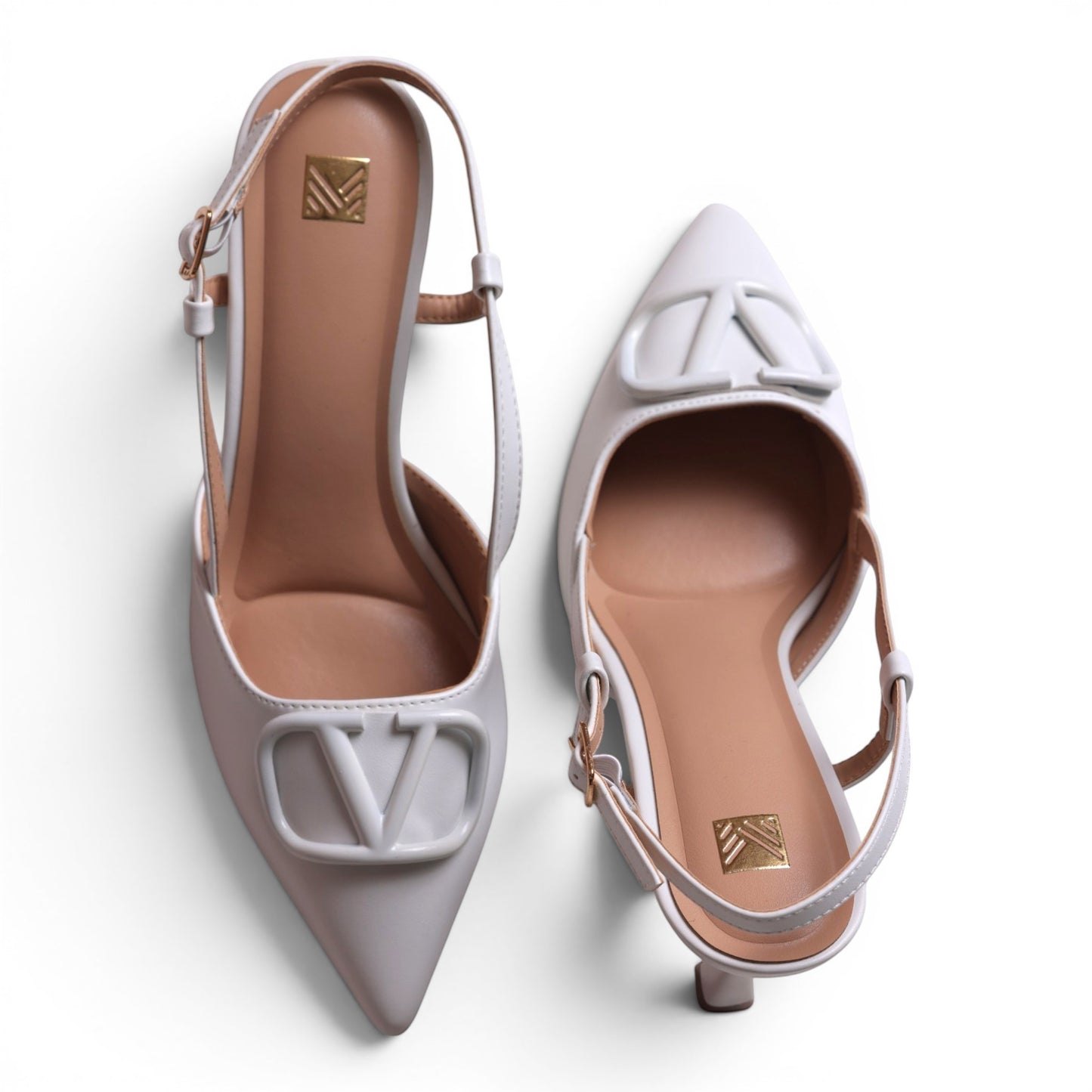 Moda Ug white leather slingback heels with pointed toe and V logo detail. Adjustable ankle strap.