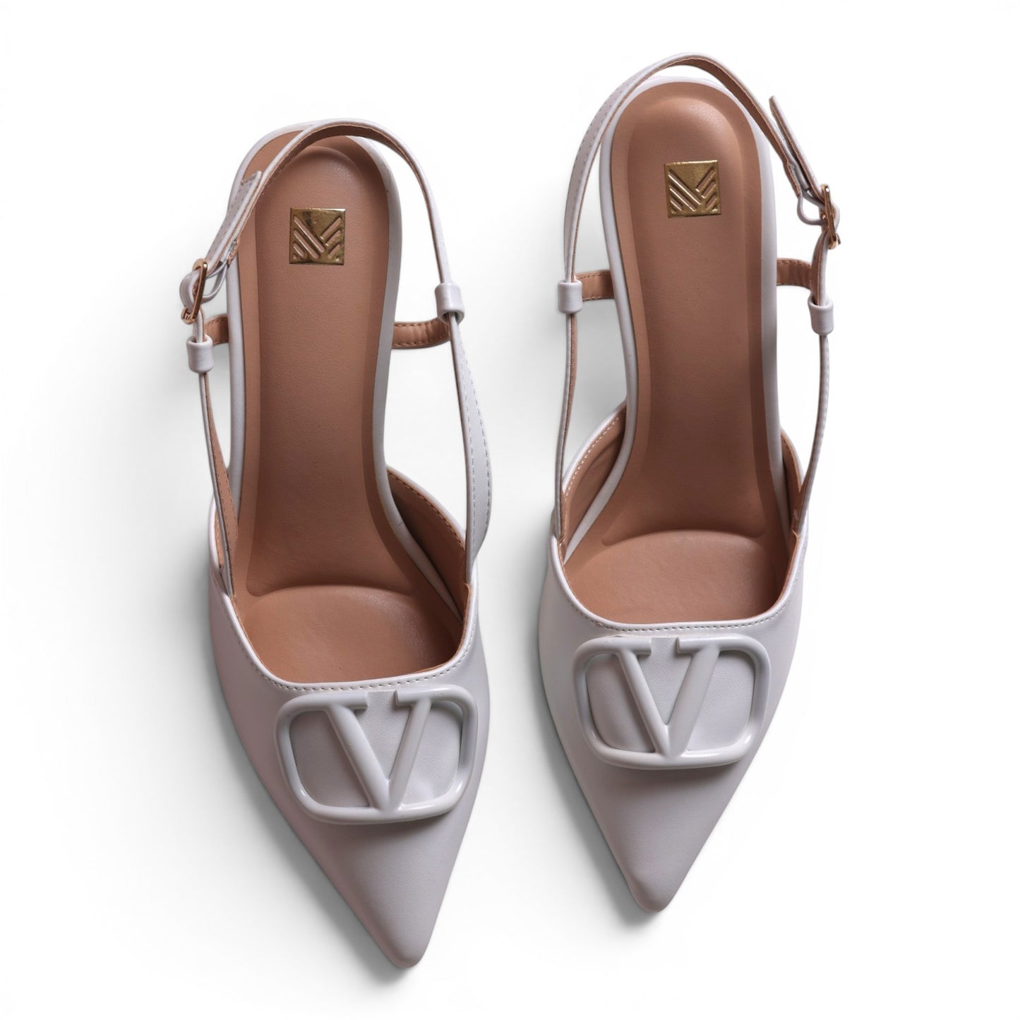 Moda Ug white leather slingback heels with pointed toe and V logo detail. Adjustable ankle strap.