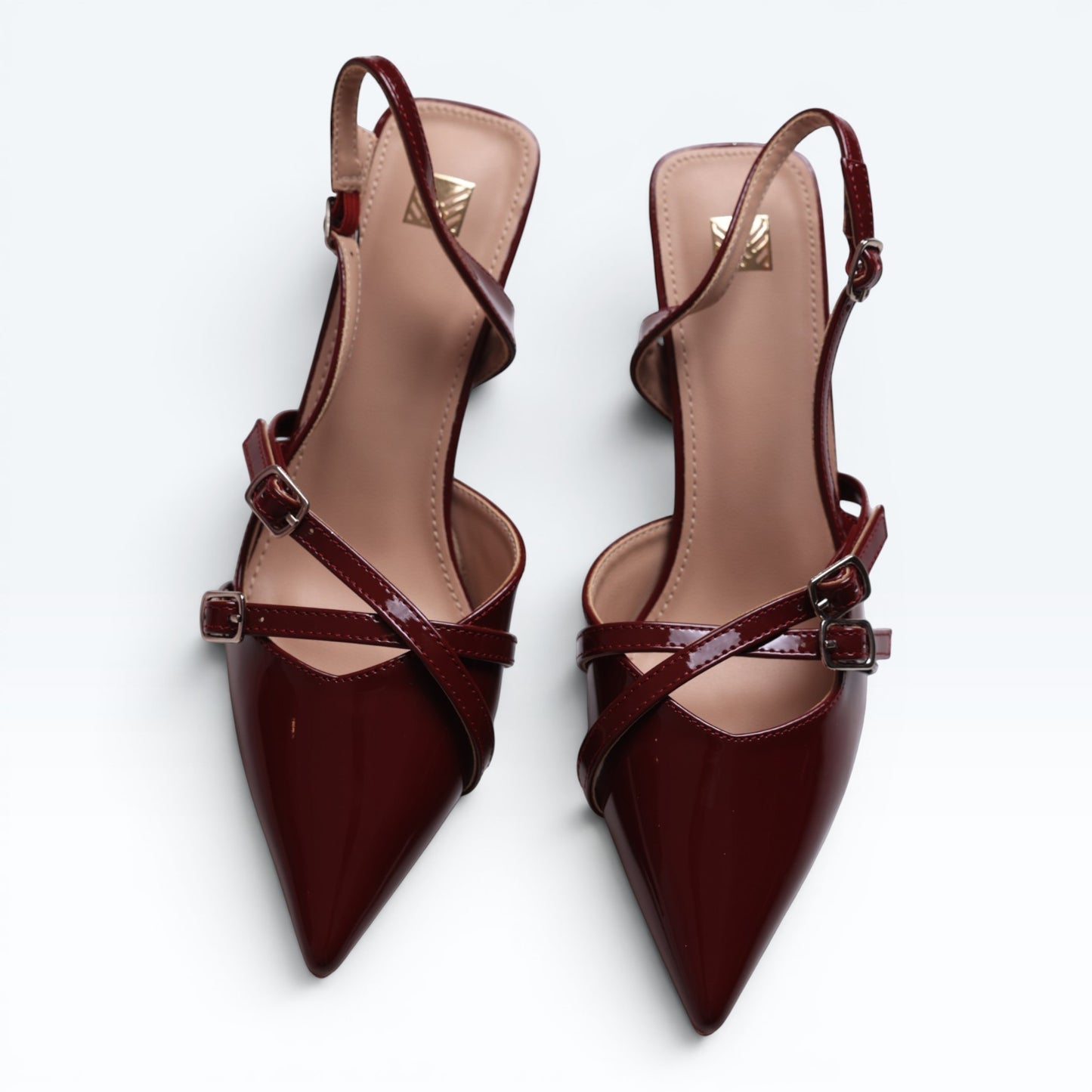 Moda Ug wine-red patent leather slingback heels with asymmetric multi-strap design and silver buckles.