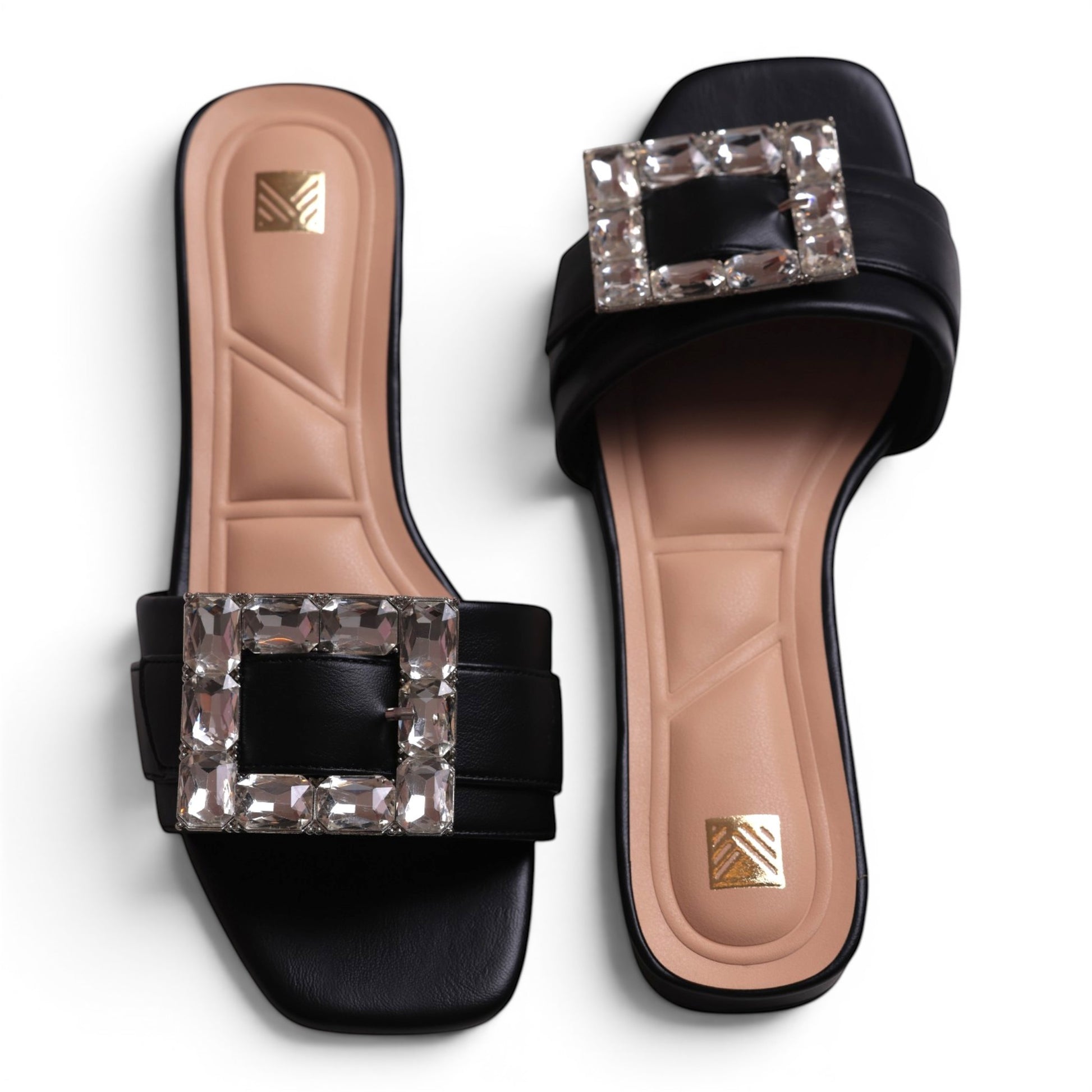 Moda Ugo black slide sandals with square crystal embellishments and padded tan footbed.