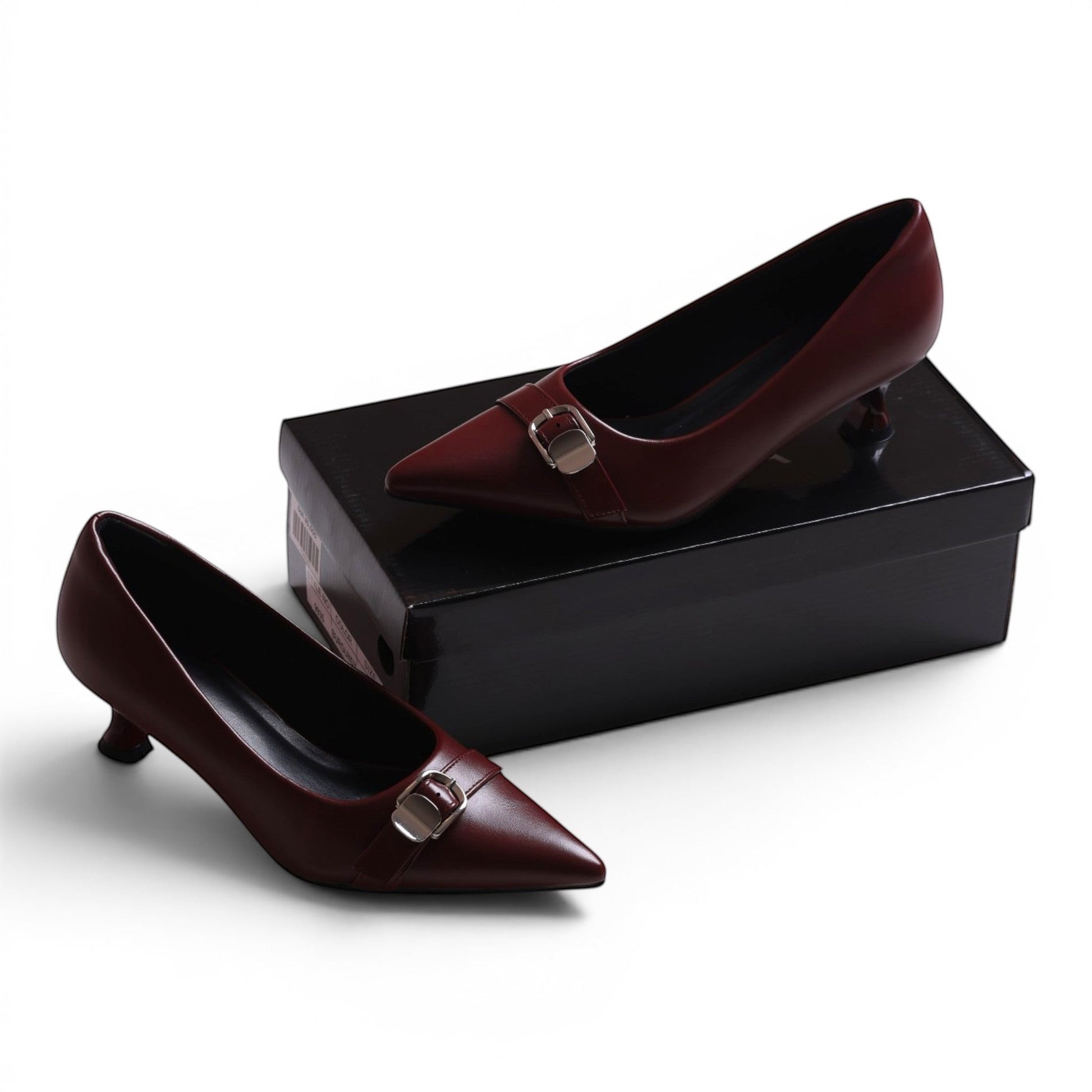 Moda Ugo burgundy leather pointed-toe kitten heel pumps with silver buckle detail.